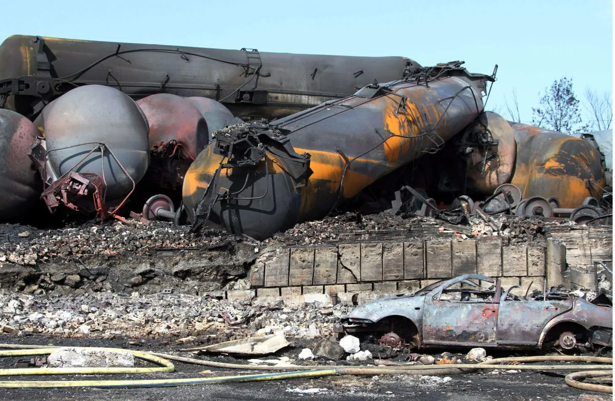 Transport Minister Lisa Raitt brought in tough new regulations on April 23, 2014 that require DOT-111 tank cars, like those pictured above at Lac-Mégantic, Quebec, after a fatal derailment, be upgraded or taken off the tracks. (The Canadian Press/Surete du Quebec)