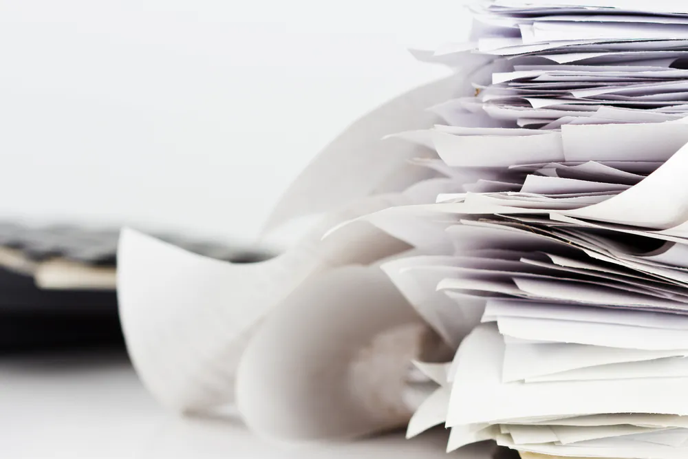 Image of a paper stack via Shutterstock