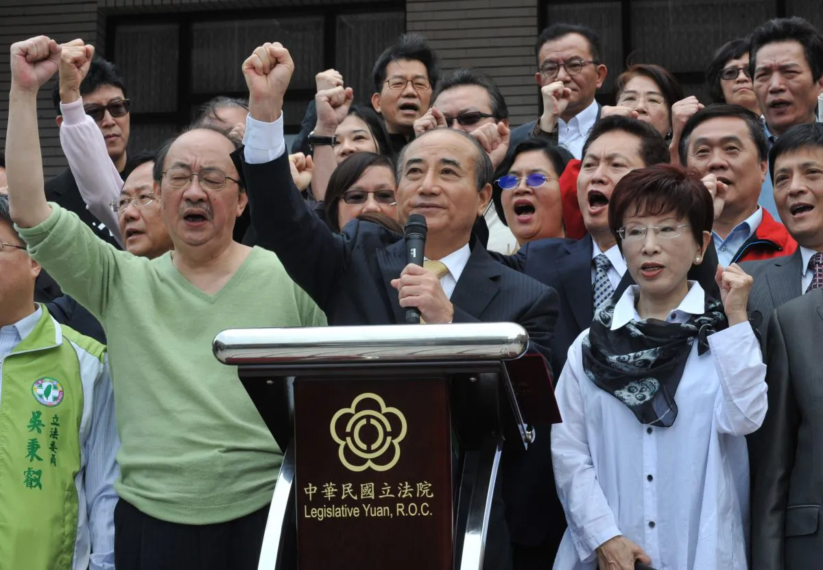 Taiwan's Parliament Speaker Wang Jin-pyng (front C) and legislators from the ruling Kuomintang (KMT) party shout slogans in front of Parliament in Taipei on April 6, 2014. Wang announced not to review the China-Taiwan trade pack before an oversight bill passes. (Mandy Cheng/AFP/Getty Images)