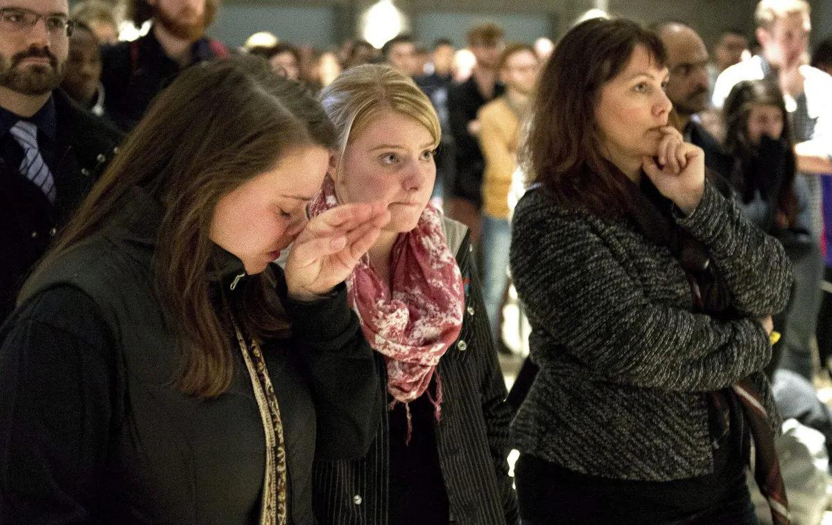 University of Calgary students and staff get emotional during a university memorial service for victims of the multiple fatal stabbing in the northwest area of the city on April 15, 2014. (The Canadian Press/Larry MacDougal)