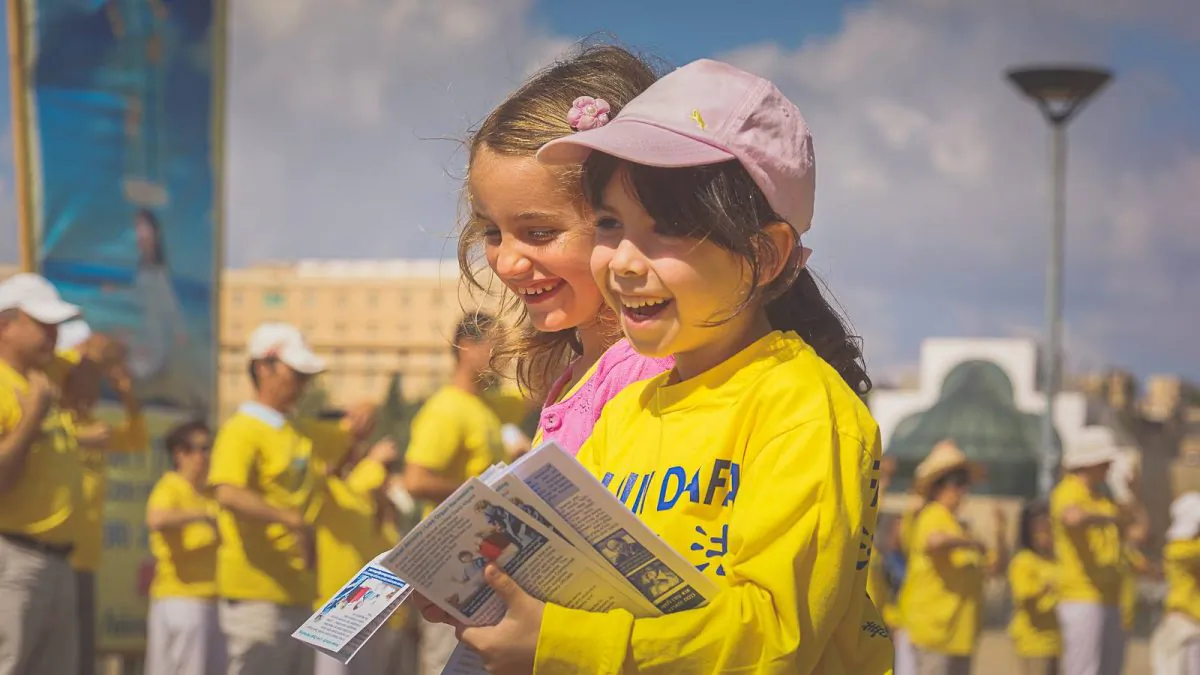 Young Falun Gong practitioners give out fliers about the discipline, on May 9, 2014 outside the Jaffa Gate in Jerusalem. (Vadim Berestetsky)