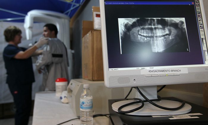 A man receives an x-ray in this file photo. The essential question of today's healthcare is whether more people will get health insurance coverage and care, and whether the quality of that care will be better. (Justin Sullivan/Getty Images)