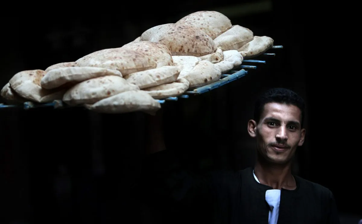 An Egyptian worker carries bread in a bakery in Cairo on October 22, 2011. (Mahmud Hams/AFP/Getty Images)