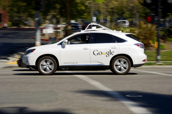 A man drives a Google Inc. self-driving car in front of the company's headquarters in Mountain View, California. (David Paul Morris/Bloomberg via Getty Images)