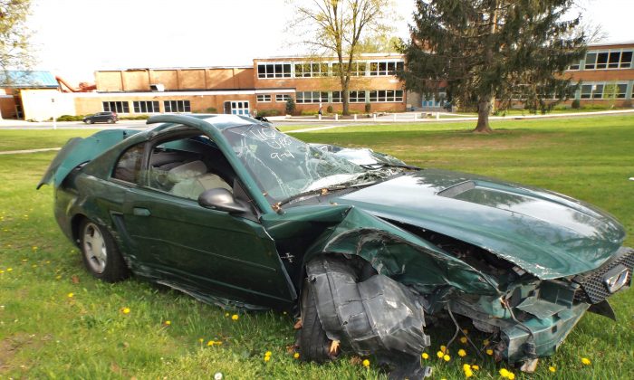 Mustang wreck on the lawn at the entrance of Millburn High School, N.J., reminding students during prom season of the dangers of driving under the influence, on May 5, 2014. (Vincent J. Bove)
