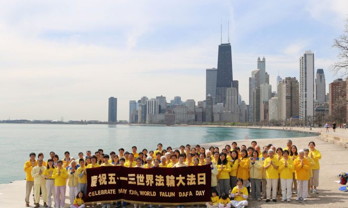 Falun Dafa practitioners in Chicago stand in a respectful pose of greeting, on May 10, 2013 on Chicago's North Beach. The practitioners intend to send the photo to Falun Dafa's founder, Mr. Li Hongzhi. (Jun Mei/Epoch Times)