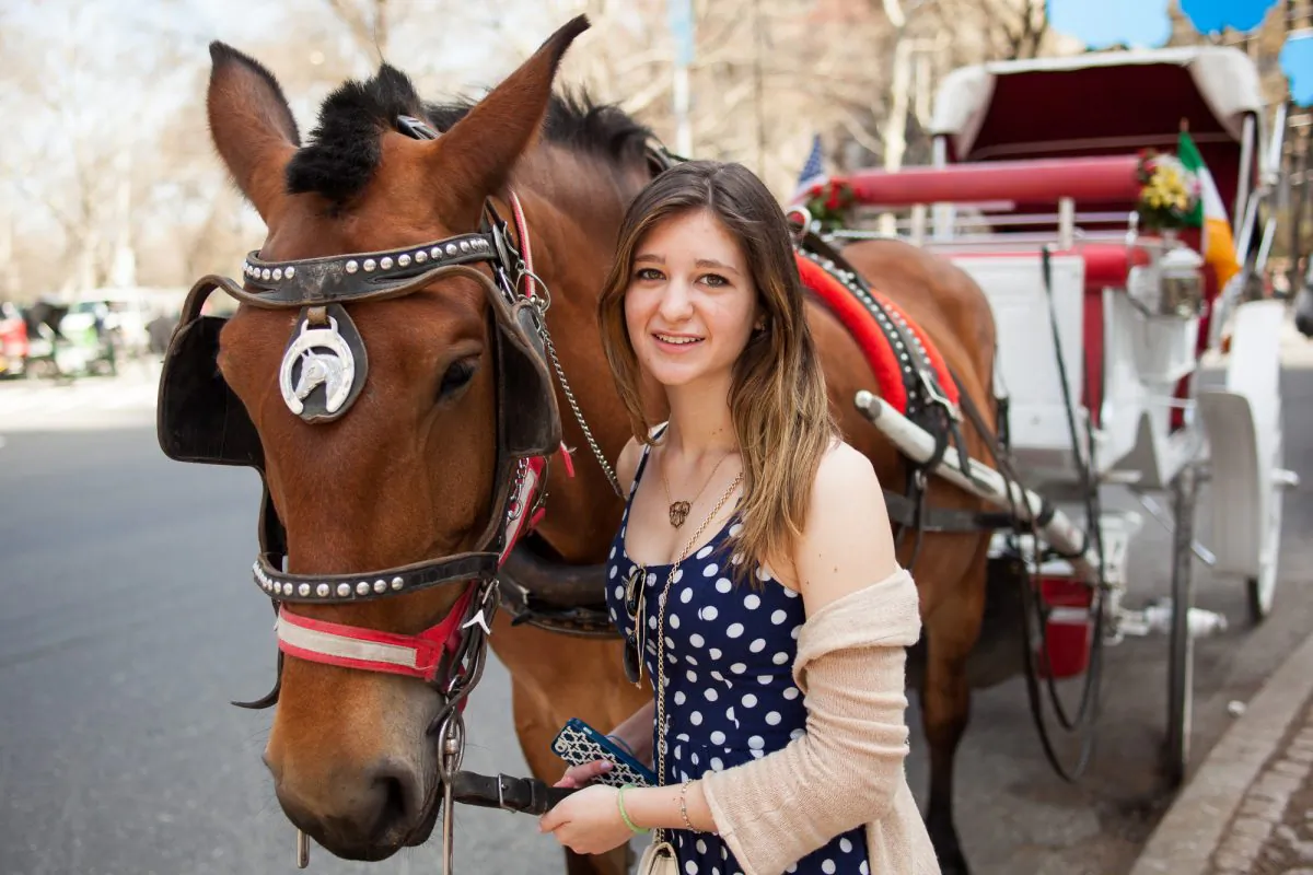 Alexandra Summa poses with 13-year-old carriage horse Rosie on Central Park South, Manhattan, April 12, 2014. (Petr Svab/Epoch Times)