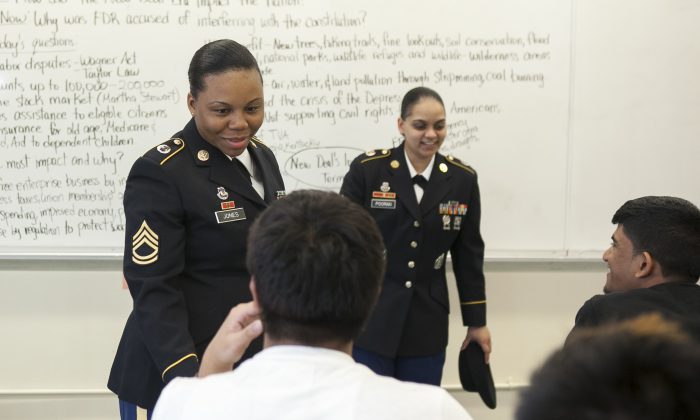 Sgt. 1st Class Meagan Jones and Staff Sgt. Kareshma Pooran from the Army Recruiting Battalion New York City visit a class at Thomas A. Edison Career and Technical High School, Jamaica, Queens, May 8. (Samira Bouaou/Epoch Times)