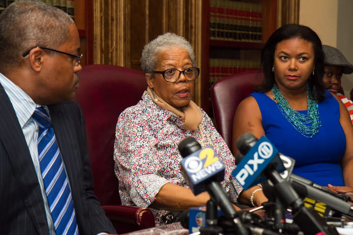 Alma Murdough, mother of former Marine Jerome Murdough, speaks as Tracy Brown (R) and Attorney Derek Sells (L) listen during a news conference about her son, who was found dead in a 100 degree cell on Rikers Island, in New York City on May 16, 2014. Sells plans to file a wrongful death lawsuit against the city on behalf of Alma Murdough for the death of her son. (Benjamin Chasteen/Epoch Times)
