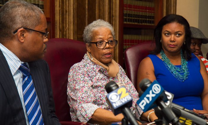 Alma Murdough, mother of former Marine Jerome Murdough, speaks as Tracy Brown (R) and Attorney Derek Sells (L) listen during a news conference about her son,  who was found dead in a 100 degree cell on Rikers Island, in New York City on May 16, 2014. Sells plans to file a wrongful death lawsuit against the city on behalf of Alma Murdough for the death of her son. (Benjamin Chasteen/Epoch Times)