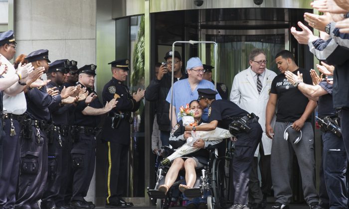 Police Officer Rosa Rodriguez leaves the Weill Cornell Medical Center on Monday. Rodriguez spent six weeks recovering from a critical injury she suffered responding to an apartment building fire on Coney Island on April 6, 2014. Her partner, Dennis Guerra, died from the injuries suffered in that fire. (Samira Bouaou/Epoch Times)
