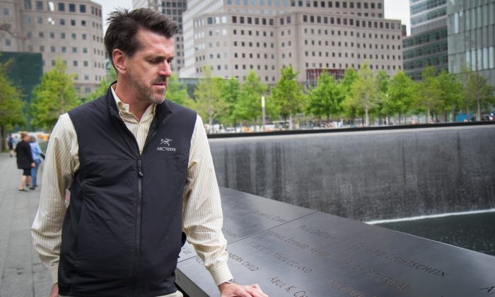John Herbst looks at his friend's name, Michael L. Collins, on the bronze parapets at the Sept. 11 memorial in New York City on May 21, 2014. (Benjamin Chasteen/Epoch Times)