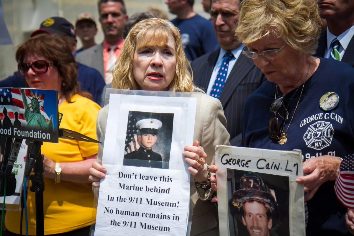 Sally Regenhard, Board Member for Christian Regenhard Center for Emergency Response Studies, (C) holds a poster of her son who died in the World Trade Center on 9/11 and is buried in the National September 11 Memorial & Museum in Manhattan, at City Hall on May 27, 2014. Regenhard, and other mothers who have also lost their sons, stand with her as she speaks out about moving the remains of the deceased from the museum at City Hall in New York City, on May 27, 2014. (Benjamin Chasteen/Epoch Times)