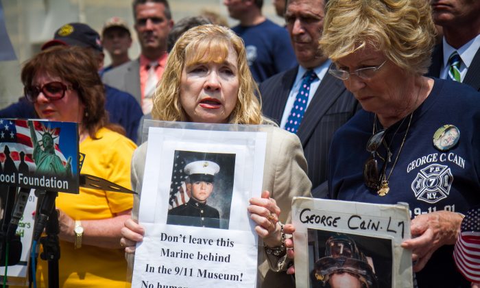 Sally Regenhard, Board Member for Christian Regenhard Center for Emergency Response Studies, (C) holds a poster of her son who died in the World Trade Center on 9/11 and is buried in the National September 11 Memorial & Museum in Manhattan, at City Hall on May 27, 2014. Regenhard, and other mothers who have also lost their sons, stand with her as she speaks out about moving the remains of the deceased from the museum at City Hall in New York City, on May 27, 2014. (Benjamin Chasteen/Epoch Times)