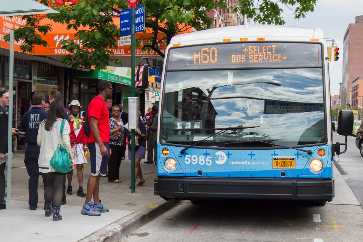 People wait to board the new M60 Select Bus Service in Harlem, Manhattan, on  May 27, 2014., (Benjamin Chasteen/Epoch Times)
