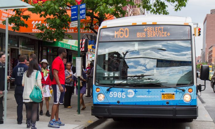 People wait to board the new M60 Select Bus Service in Harlem, Manhattan, on  May 27, 2014., (Benjamin Chasteen/Epoch Times)
