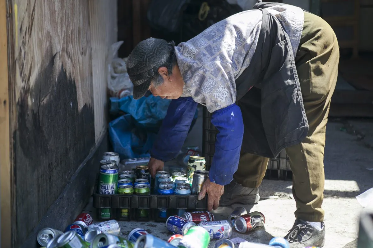 Yabi Luo, an immigrant who collects cans from trash receptacles for a living, sorts her cans at the Sure We Can redemption center in Bushwick, Brooklyn. (Samira Bouaou/Epoch Times)