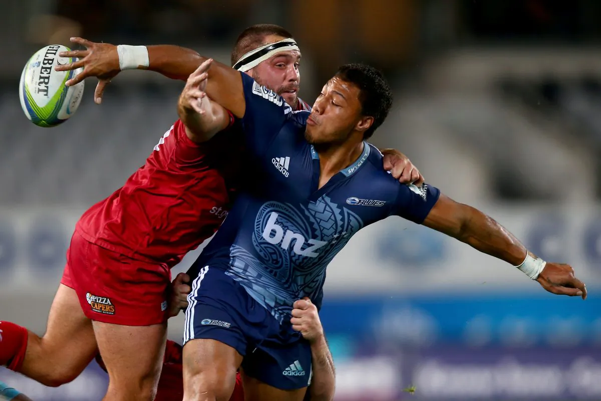 Blues winger George Moala offloads in the tackle of Reds hooker James Hanson during their Round 12 Super Rugby match on Friday May 2, 2014. (Phil Walter/Getty Images)