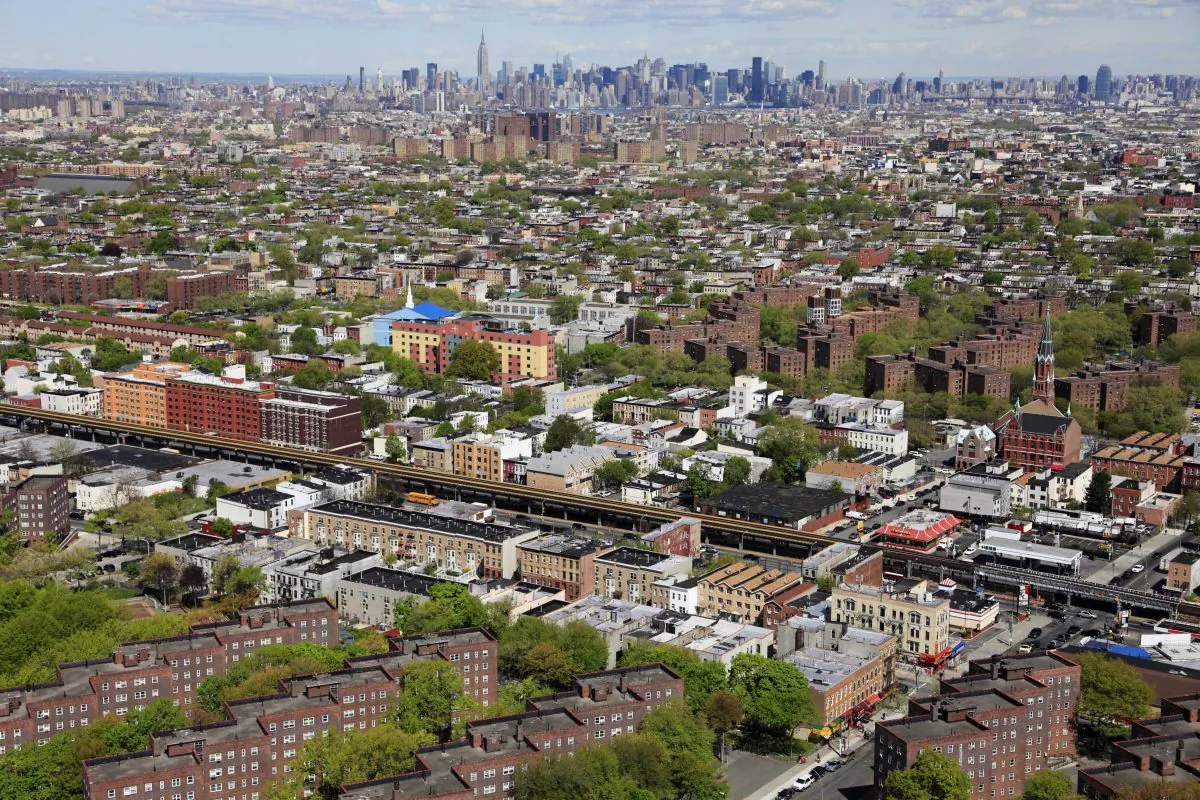 The Brooklyn borough of New York is shown in this April 20, 2010, aerial photo. The Manhattan skyline is in the distance. Mayor Bill de Blasio has an ambitious plan is to build or preserve 200,000 affordable units of housing over the next 10 years for lower-income New Yorkers, a staggering number that would house a population bigger than cities such as Atlanta or Minneapolis. (AP Photo/Mark Lennihan)