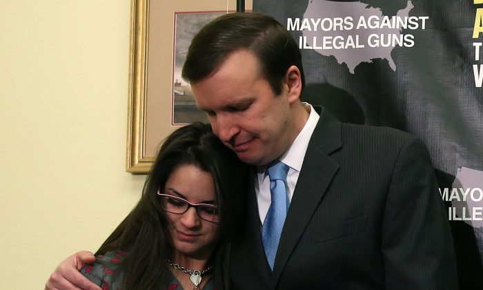 Sen. Chris Murphy (D-CT) hugs Carlee Soto, sister of Newtown victim and Sandy Hook teacher Victoria Soto, on Capitol Hill in Washington, Feb. 12. (Mark Wilson/Getty Images)