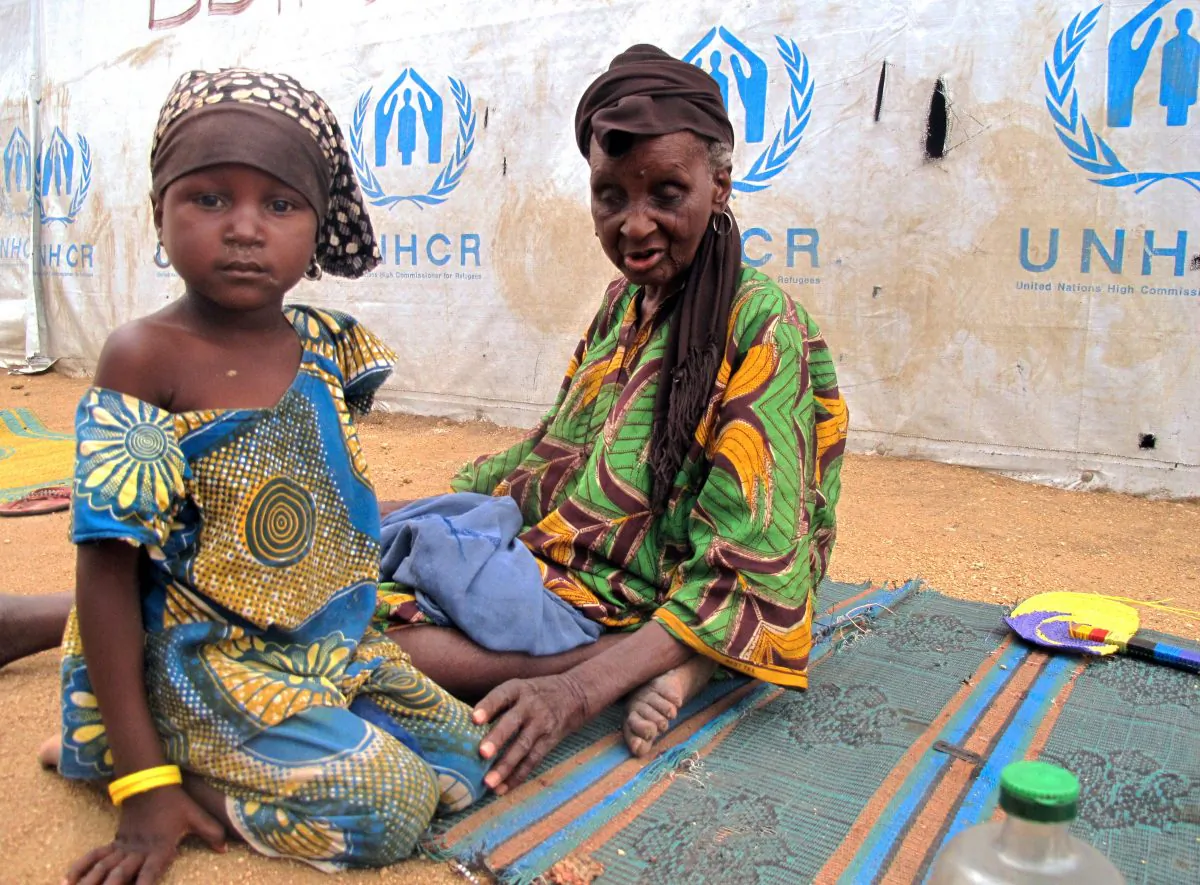 A file photo of a little girl and an elderly woman sit in the refugee camp of Minawao near the border of Nigeria and Cameroon. Many have fled fighting between the Nigerian army and the Islamist rebels Boko Haram, who have targeted schools and recently kidnapped schoolgirls. (Reinnier Kaze/AFP/Getty Images)