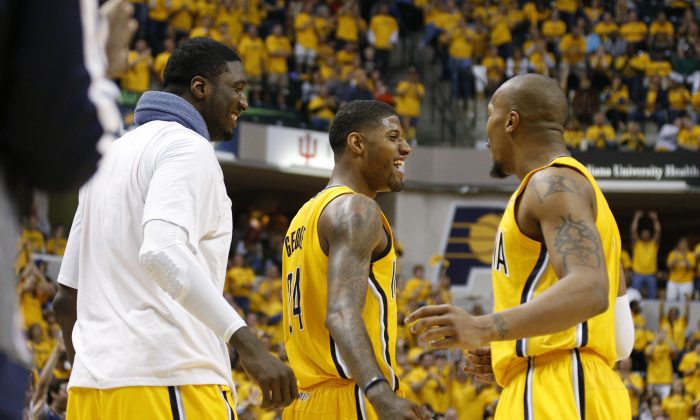 Paul George #24 of the Indiana Pacers celebrates with Roy Hibbert #55 and David West #21 during Game Seven of the Eastern Conference Quarterfinals of the 2014 NBA Playoffs against the Atlanta Hawks on May 3, 2014 at Bankers Life Fieldhouse in Indianapolis, Indiana. The Pacers won 92-80. (Joe Robbins/Getty Images)