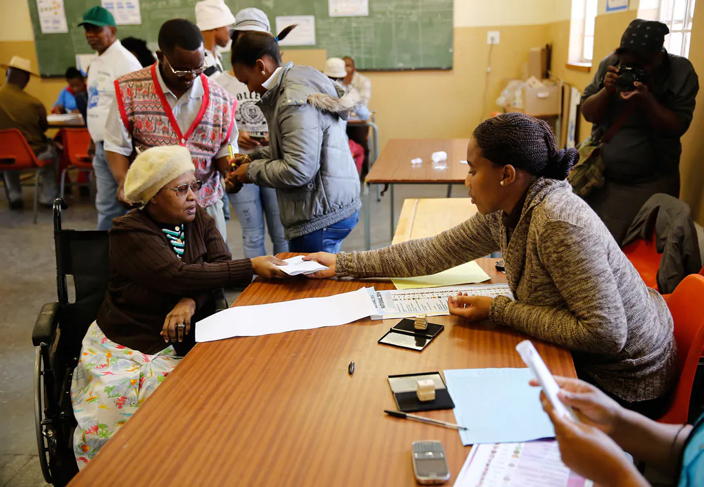 Fibongeni Ellen Ndalovevu has her identification checked prior to voting at the Orlando West Voting Station at the Orlando West Secondary School during the 2014 South African General Election on May 7, 2014 in the Soweto Township in Johannesburg, South Africa. Polls have opened in South Africa's fifth general election since the end of apartheid over 20 years ago. President Jacob Zuma is expected to return to power with the ANC party however his election campaign has been marred by allegations of corruption and he is expected to lose some ground to other parties. (Jemal Countess/Getty Images)