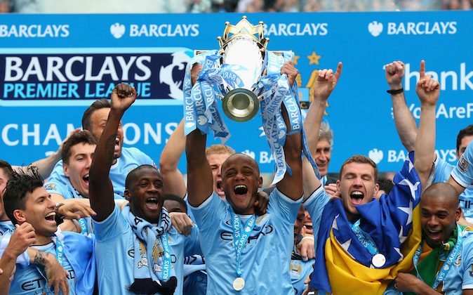 Vincent Kompany of Manchester City lifts the Premier League trophy at the end of the Barclays Premier League match between Manchester City and West Ham United at the Etihad Stadium on May 11, 2014 in Manchester, England. (Photo by Alex Livesey/Getty Images)