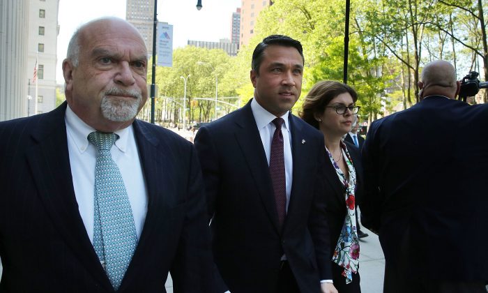 New York Rep. Michael Grimm (C) walks into a Brooklyn Federal Court hearing May 19, 2014, after an April indictment on 20 counts. (Spencer Platt/Getty Images)