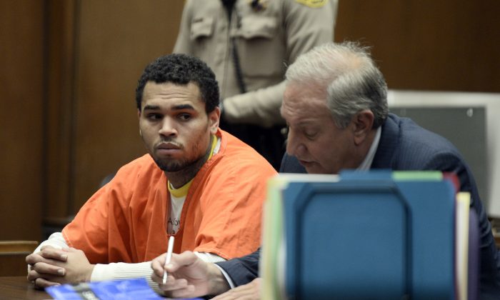 Chris Brown, left is shown in court with his attorney, Mark Geragos Friday May 9, 2014 in Los Angeles. Brown on Friday admitted a probation violation over an altercation last year outside a hotel in Washington, D.C., and was sentenced to remain on probation and serve an additional 131 days in jail. (AP Photo/Paul Buck, POOL)