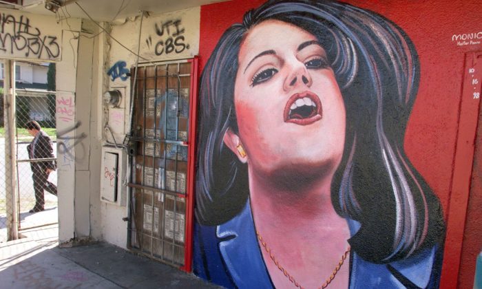 A man walks past a mural of former White House intern Monica Lewinsky in Los Angeles in this file photo. Lewinsky is coming out with a big article in Vanity Fair, to be published Thursday, May 8. (HECTOR MATA/AFP/Getty Images)