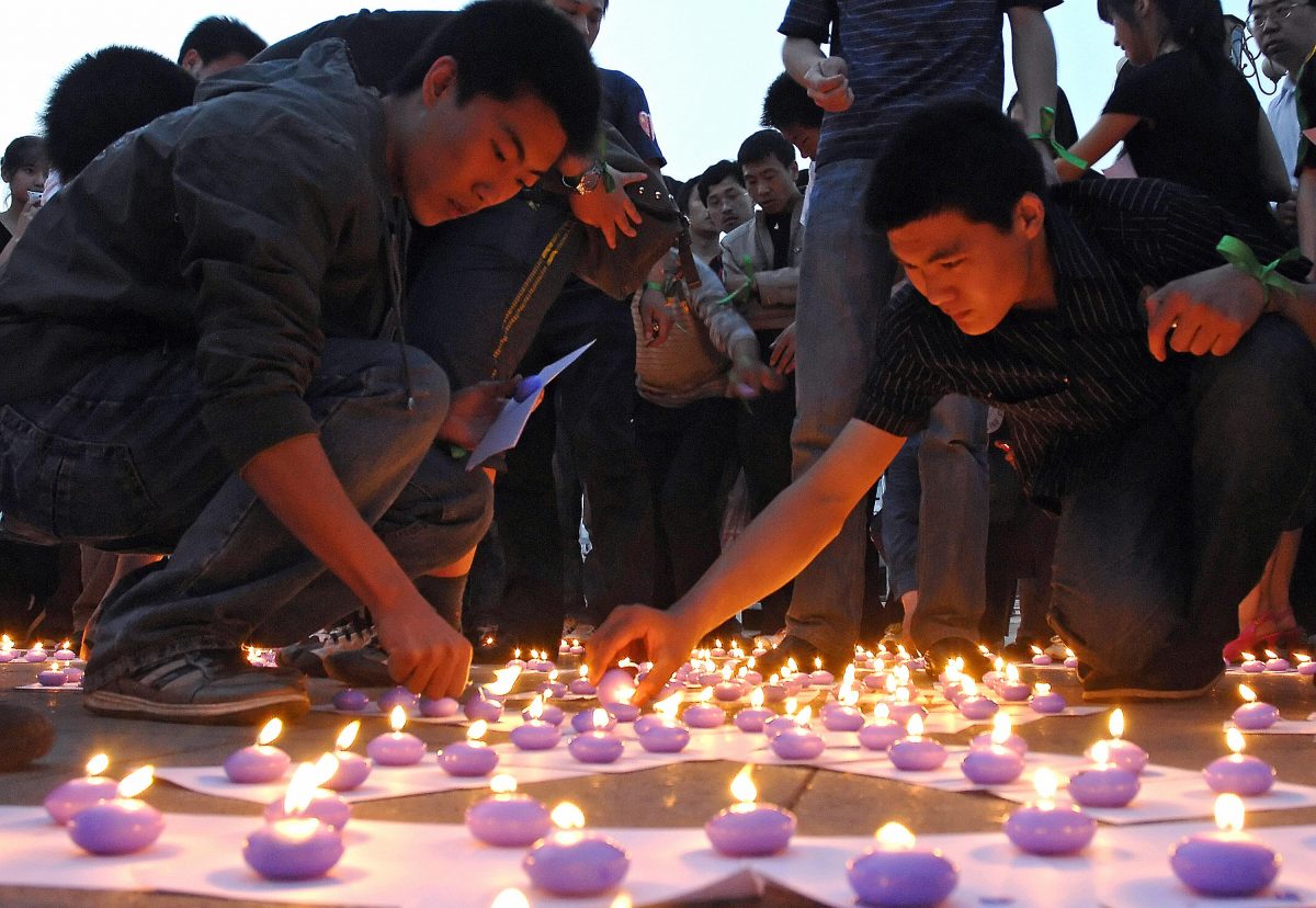 Chinese volunteers light candles at the Tangshan Earthquake Memorial Square during a memorial ceremony for the Sichuan earthquake victims on May 21, 2008. (Simon Lim/AFP/Getty Images)