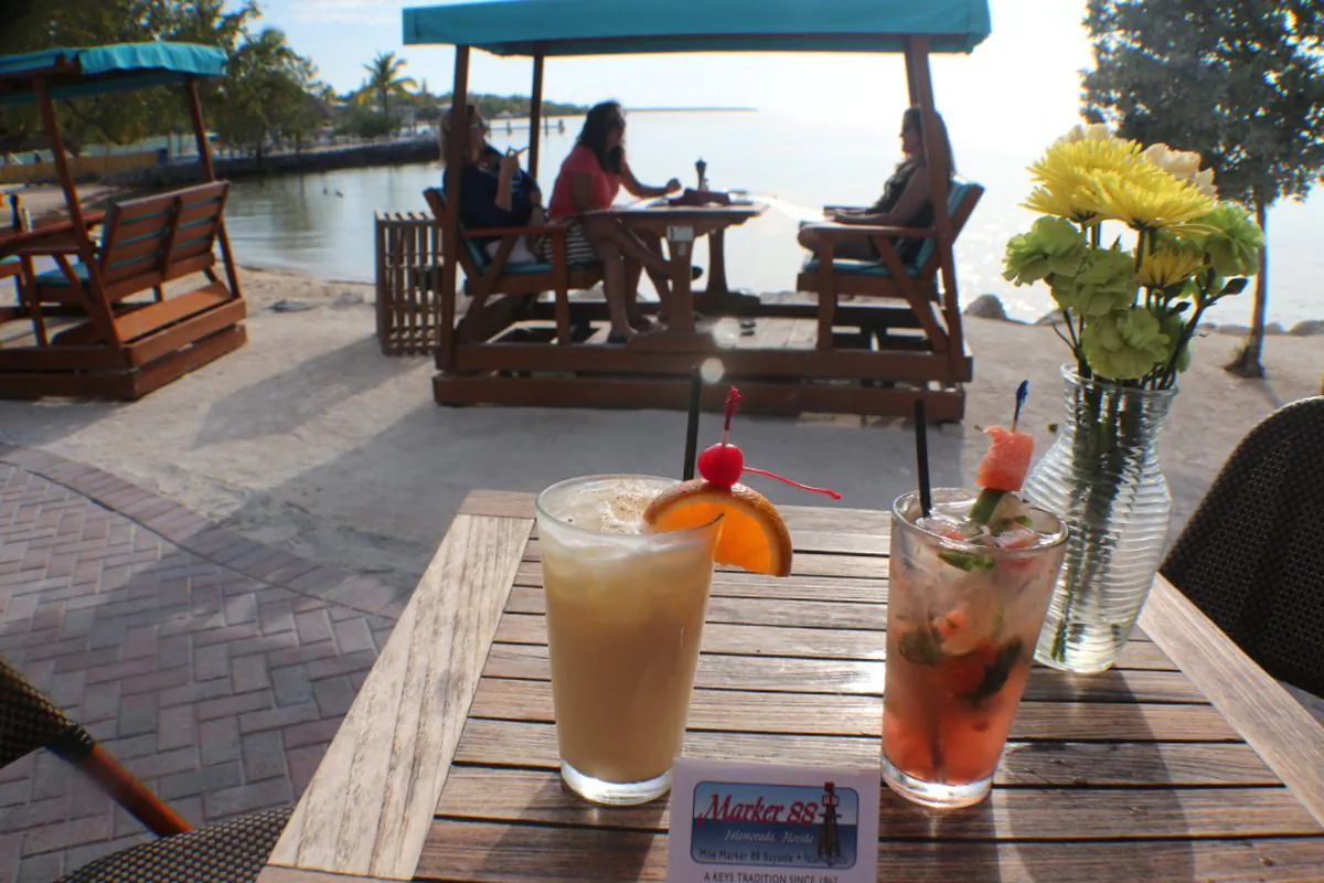 Rocker tables right on the bay seat four. Wonderful spot to enjoy tropical cocktails and dinner at Marker 88 Restaurant. (Myriam Moran copyright 2014)