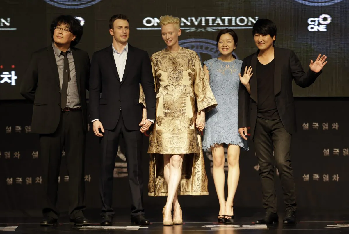 From left to right, Director Bong Joon-Ho, actor Chris Evans, actress Tilda Swinton, actress Ko A-sung and actor Song Kang-Ho pose during the world premiere event for their new film "Snowpiercer" in Seoul, South Korea, Monday, July 29, 2013. The movie is to be released in South Korea on Aug. 1. (AP Photo/Lee Jin-man)