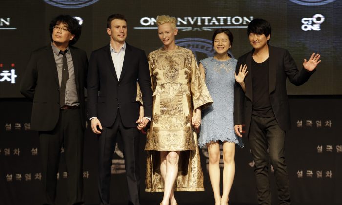 From left to right, Director Bong Joon-Ho, actor Chris Evans, actress Tilda Swinton, actress Ko A-sung and actor Song Kang-Ho pose during the world premiere event for their new film "Snowpiercer" in Seoul, South Korea, Monday, July 29, 2013. The movie is to be released in South Korea on Aug. 1. (AP Photo/Lee Jin-man)