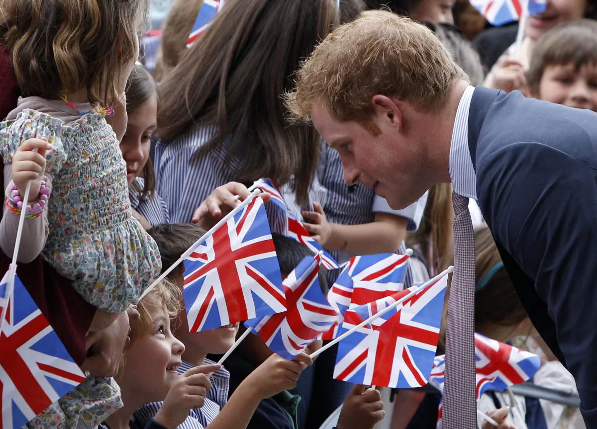 Britain's Prince Harry greets children waving UK flags as he arrives at the MAXXI Museum for an unveiling ceremony of the British pavillion at Milan's Expo 2015, in Rome, Sunday, May 18, 2014. (AP Photo/Riccardo De Luca)