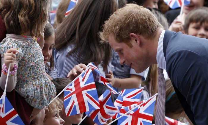 Britain's Prince Harry greets children waving UK flags as he arrives at the MAXXI Museum for an unveiling ceremony of the British pavillion at Milan's Expo 2015, in Rome, Sunday, May 18, 2014. (AP Photo/Riccardo De Luca)