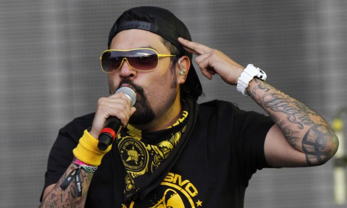 In this March 17, 2013 file photo, Luis Ramon Ibarra, lead vocalist for the Mexican band Panteon Rococo, performs at the Vive Latino music festival in Mexico City. Mexico's Interjet airline said Wednesday May 28, 2014, it regrets an incident in which members of a Mexican rock band were told they couldn't board a plane until they covered up their arms, which bore tattoos. (AP Photo/Marco Ugarte,File)