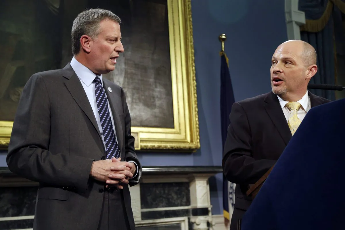 President of the United Federation of Teachers Michael Mulgrew (R) and Mayor Bill de Blasio announce a contract deal at City Hall in Manhattan on May 1. (Seth Wenig/AP)