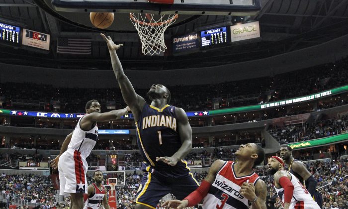 Indiana Pacers guard Lance Stephenson (1) shoots between Washington Wizards forward Martell Webster (9) and Washington Wizards guard Bradley Beal (3) in the second half of an NBA basketball game, Friday, March 28, 2014, in Washington. The Wizards won 91-78. (AP Photo/Alex Brandon)