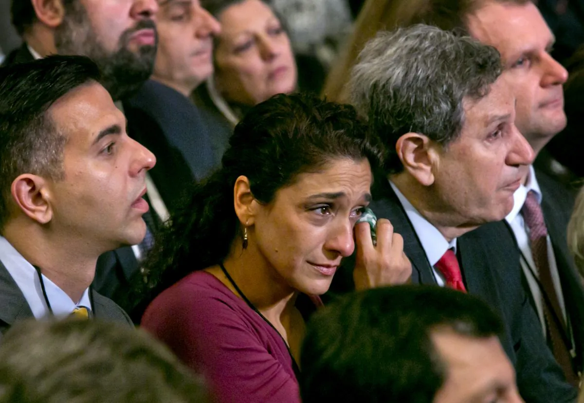 A woman in the audience dries a tear during the dedication ceremony in Foundation Hall of the National September 11 Memorial Museum in Lower Manhattan. (Richard Drew/AP)