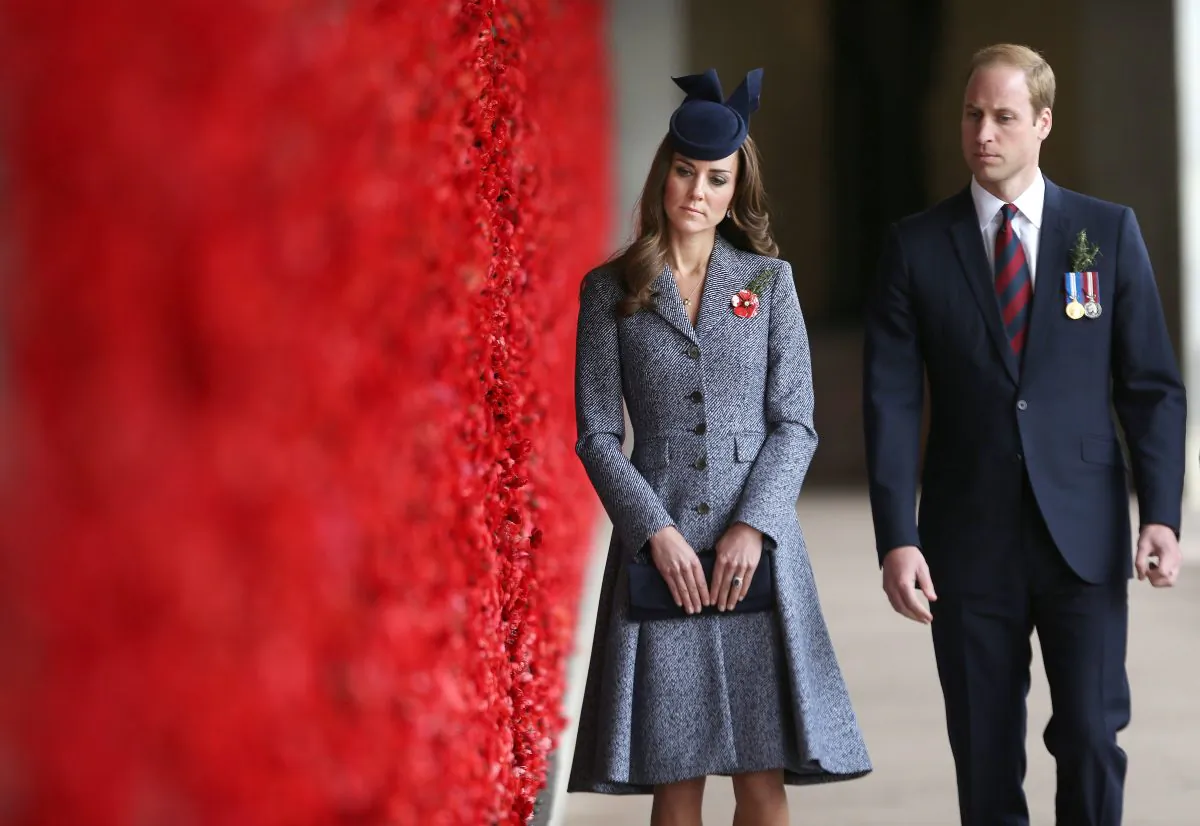 Britain's Prince William and his wife Kate, the Duchess of Cambridge, walk along the poppy flower-lined Wall of Remembrance during their visit at the Australian National War Memorial on Anzac Day in Canberra, Australia, Friday, April 25, 2014. Australia and New Zealand on Friday marked the 99th anniversary of the first major military action involving Australian and New Zealand forces during the First World War. ANZAC is an acronym for Australia and New Zealand Army Corps. (AP Photo/Gary Ramage, Pool)