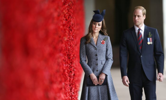 Britain's Prince William and his wife Kate, the Duchess of Cambridge, walk along the poppy flower-lined Wall of Remembrance during their visit at the Australian National War Memorial on Anzac Day in Canberra, Australia, Friday, April 25, 2014. Australia and New Zealand on Friday marked the 99th anniversary of the first major military action involving Australian and New Zealand forces during the First World War. ANZAC is an acronym for Australia and New Zealand Army Corps. (AP Photo/Gary Ramage, Pool)