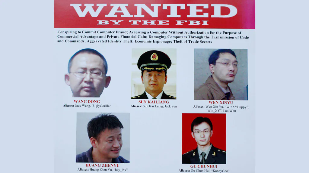 The five Chinese hackers that a U.S. grand jury has charged, are displayed on posters in Washington, on May 19, 2014. (AP Photo/Charles Dharapak)