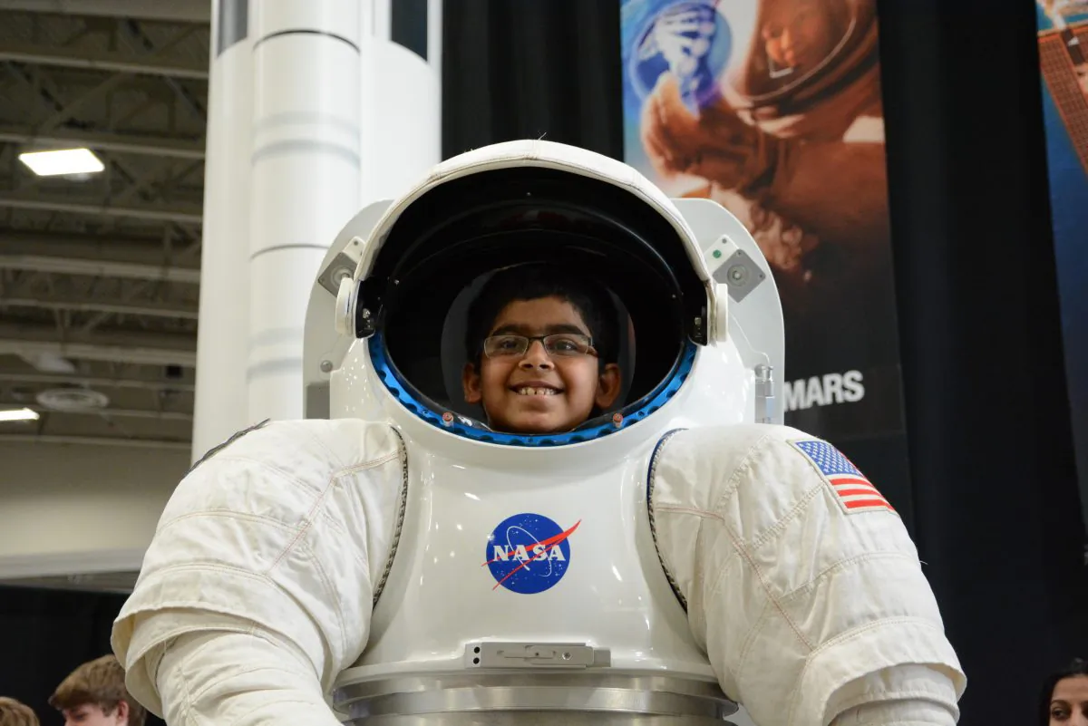 A future astronaut? A child enjoys a NASA display at the USA Science & Engineering Festival in Washington, D.C. (Du Won Kang/Epoch Times)