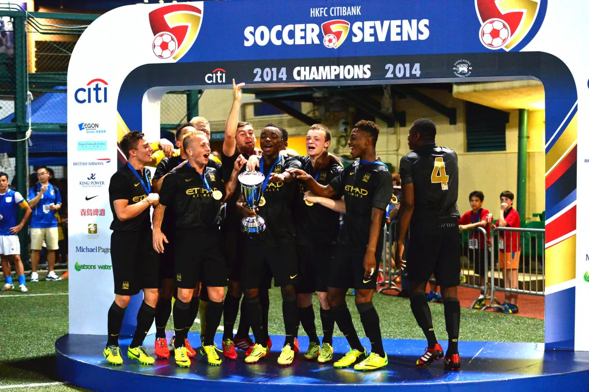 Manchester City development squad celebrate winning the HKFC Citibank Soccer Sevens 2014 in an exciting and tight contest with local team Kitchee at the Hong Kong Football Club on Sunday May 25, 2014. (Bill Cox/Epoch Times)