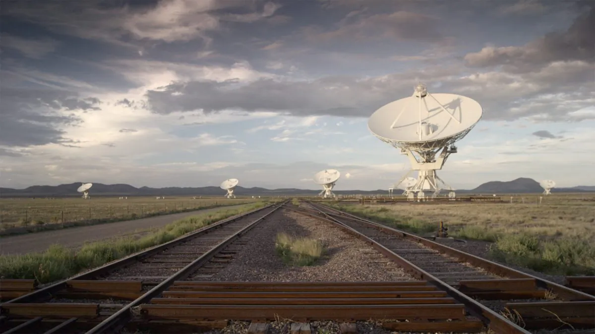 Satellite dishes surround railroad tracks in New Mexico in "Focus on Infinity." (Courtesy of Hot Docs)