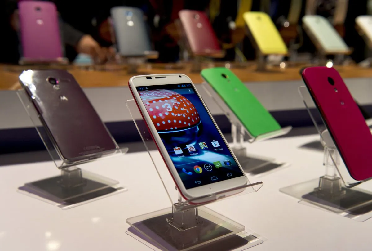 Motorola Mobility's Moto X smartphone is displayed in different colors at a a news conference in New York, Aug. 1, 2013. Apple and Google, which owns Motorola, have agreed to drop all pending patent lawsuits related to smartphones. 
 (Don Emmert/AFP/Getty Images)
