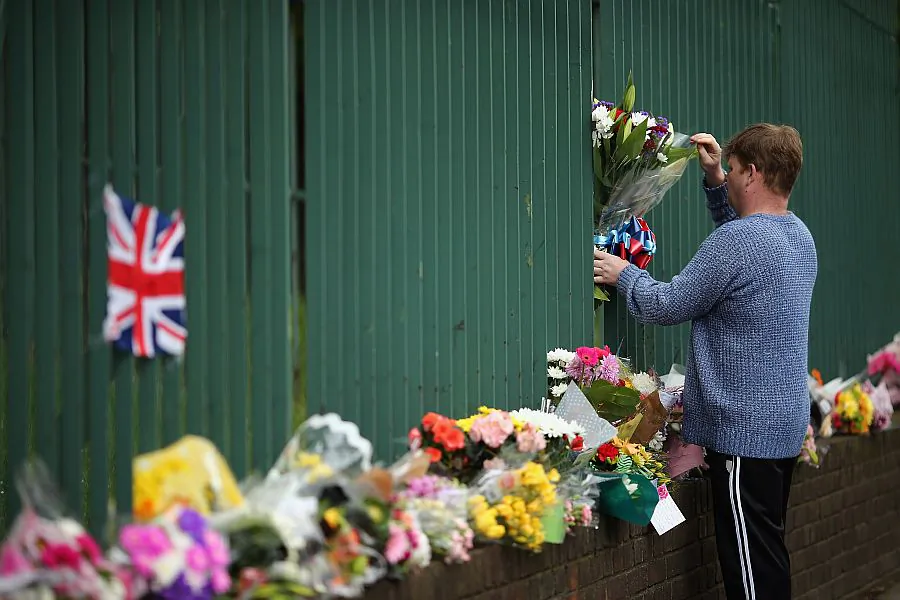 Members of the community lay flowers in London on May 24, 2013. The pictured location is near Woolwich Army Barracks and is the scene where Drummer Lee Rigby of the 2nd Battalion the Royal Regiment of Fusiliers was killed by suspected Islamists. (Dan Kitwood/Getty Images)