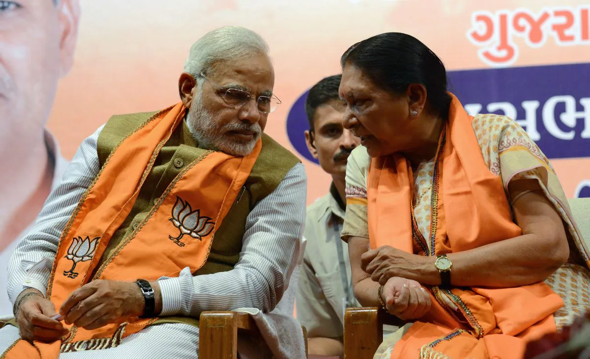 India's prime minister-elect, Narendra Modi (L), chats with Gujarat's first woman chief minister, Anandiben Patel on May 21, 2014. (Sam Panthaky/AFP/Getty Images)